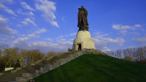 Shot showing scale of the statue on top of a hill